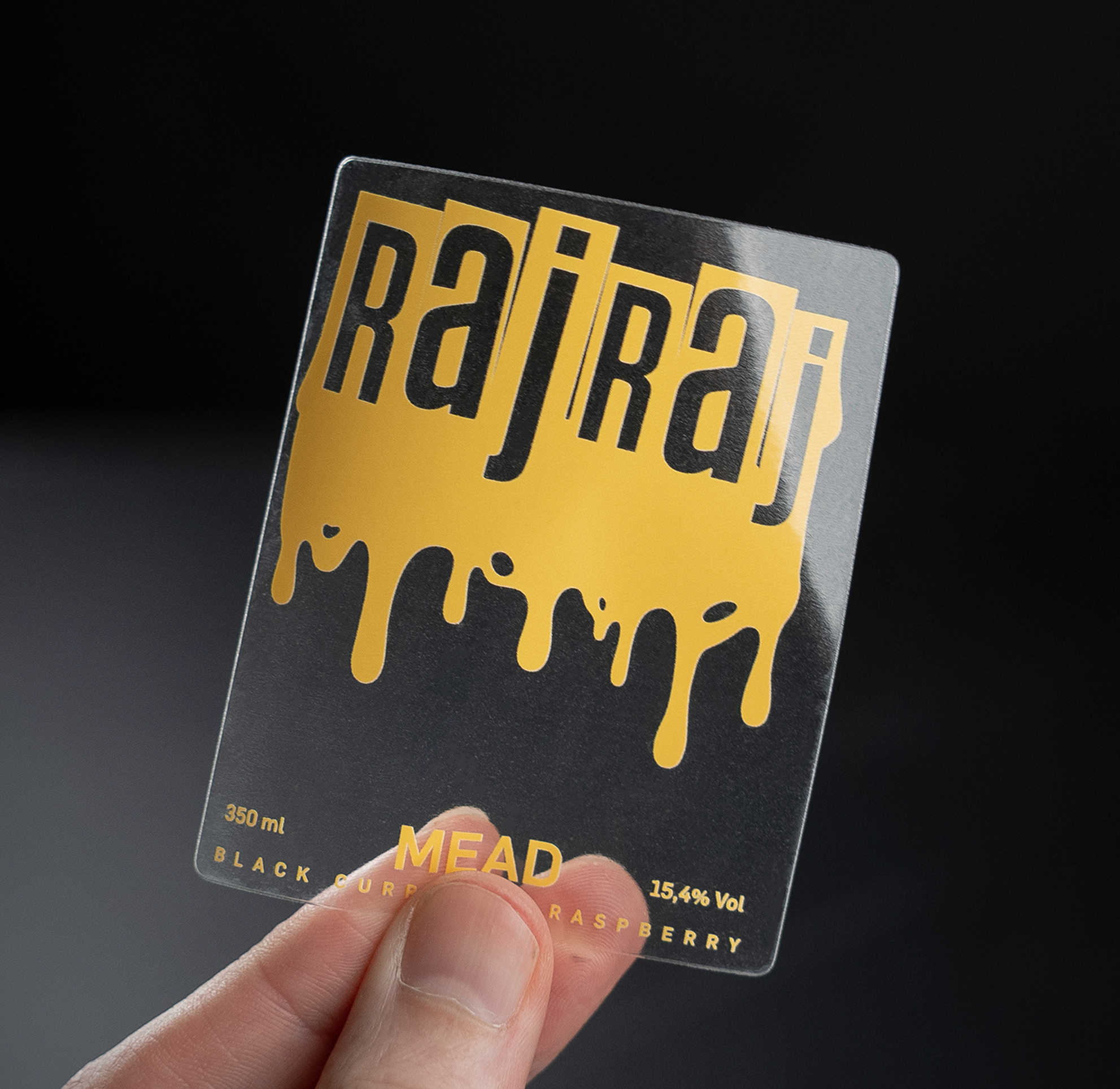 A clear label with "raj raj" in bold, dripping yellow text. Label reads: "Mead, Black Currant Raspberry, 15.4% Vol, 350 ml."