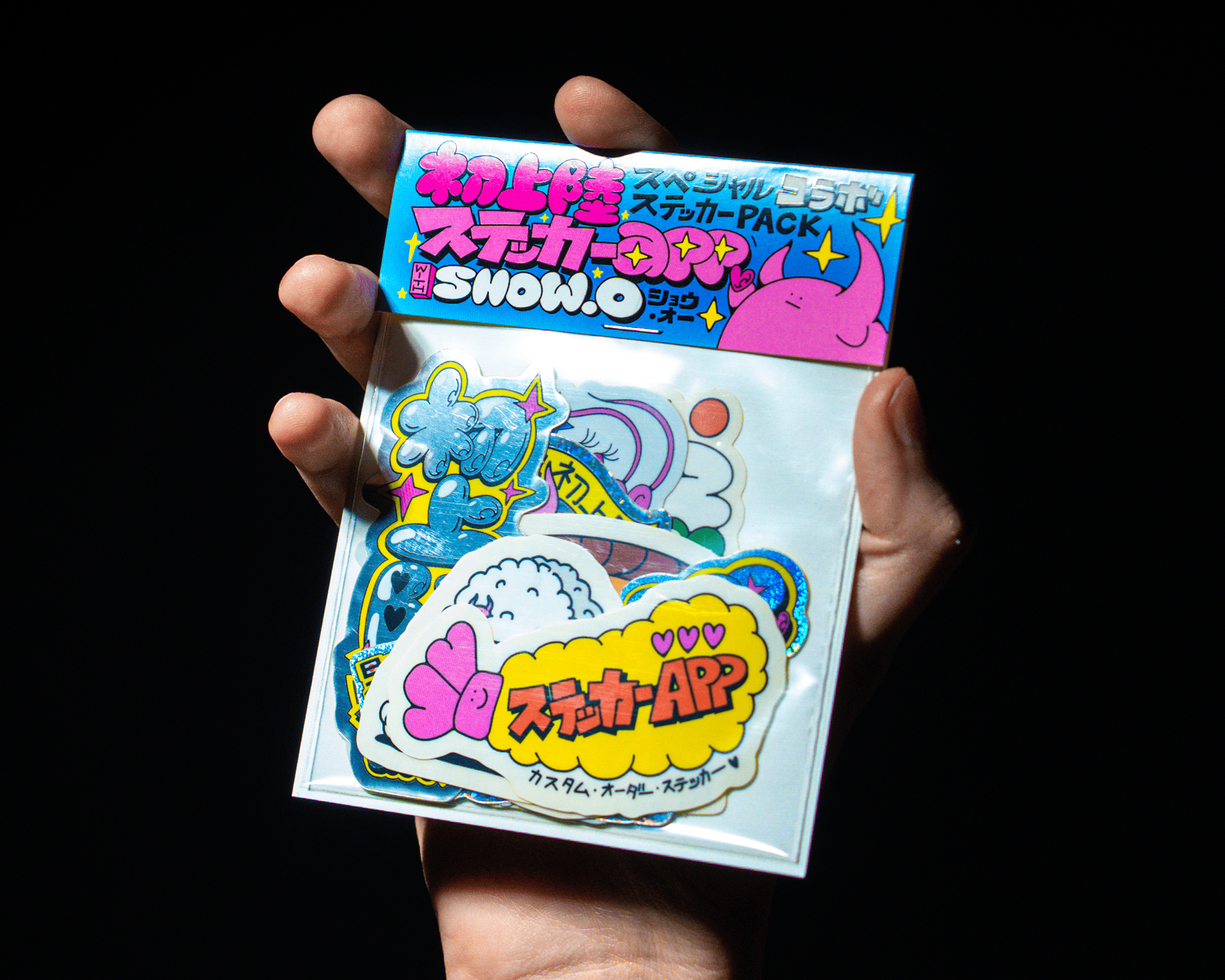 A hand holding a sticker pack