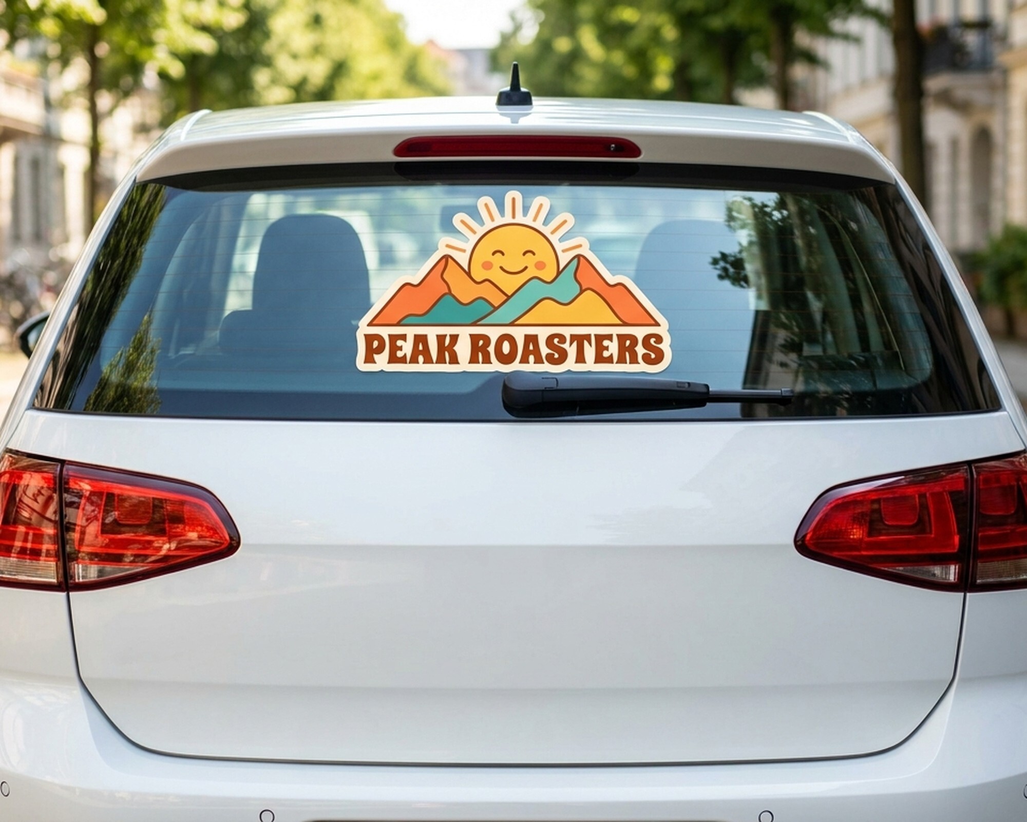 Die-cut custom decal with a sun and mountain logo reading "Peak Roasters" on a car's rear window
