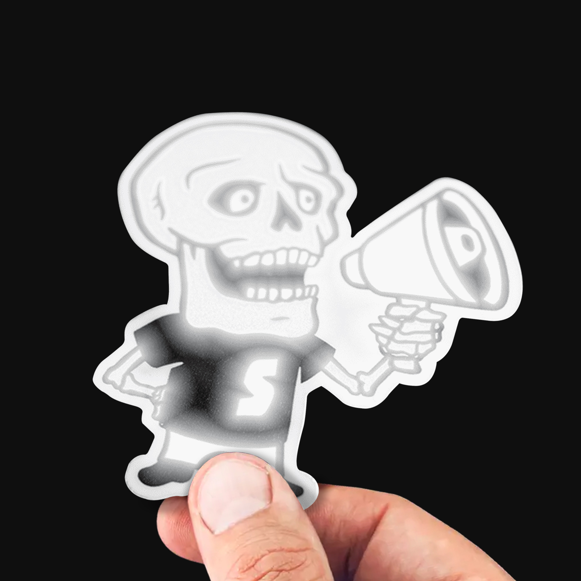 Reflective custom sticker of a cartoon skeleton holding a megaphone, wearing a T-shirt with an "S" on it.