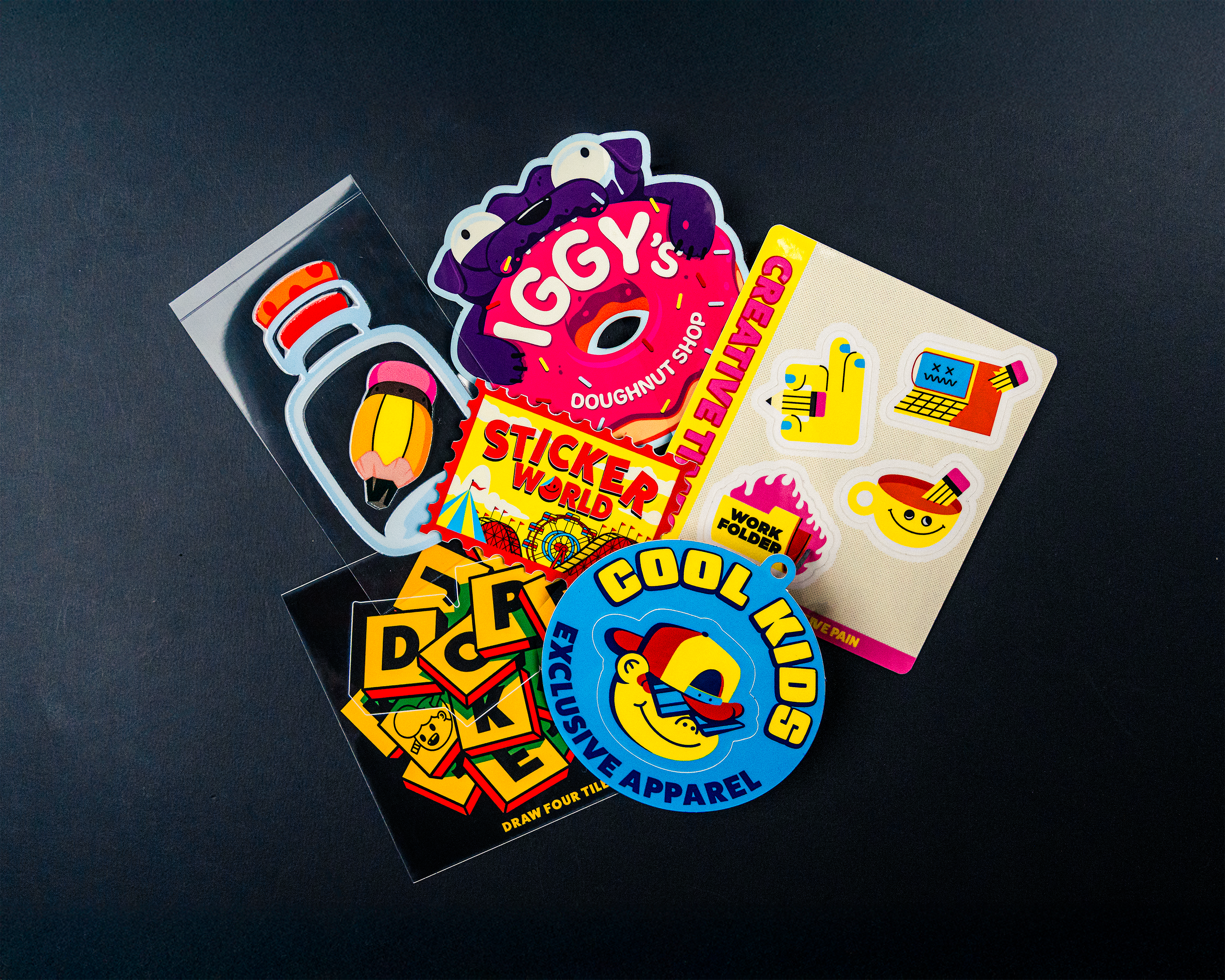 Custom Stickers all products piled on black background.